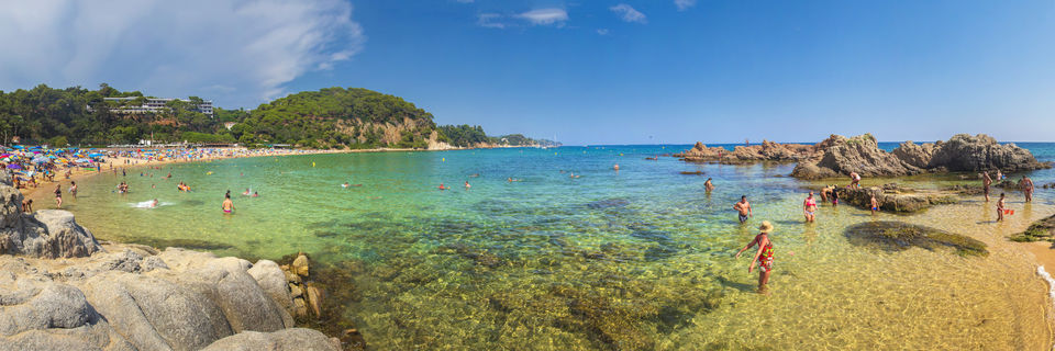 Lloret de Mar beach with people swimming